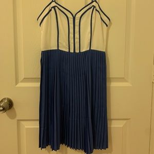Accordion pleat dress. Piped bodice.